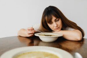 lethargic woman not interested in her soup