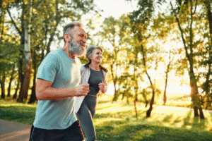 couple running in park with sunshining and leaves glistening