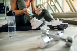 woman-tyingsports-shoe-health-club